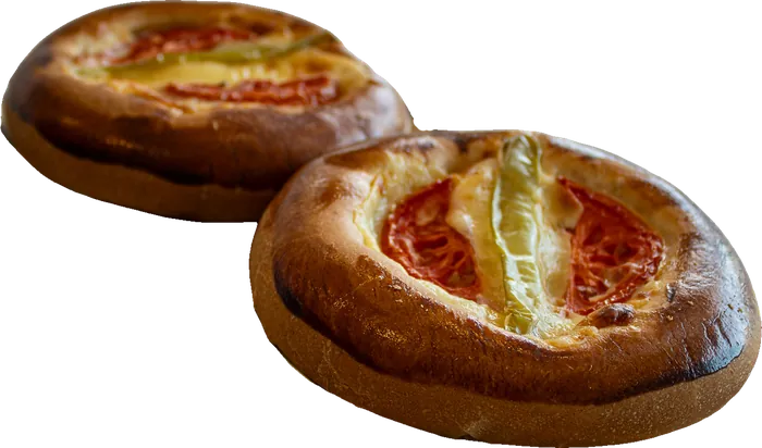 Pogaca pastries topped with tomato