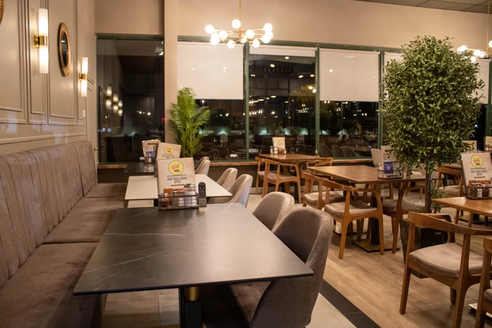 Dining room corner with seating and greenery