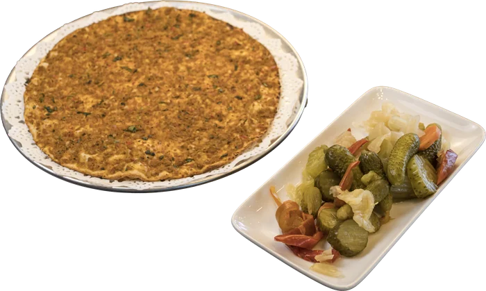 Lahmacun on a plate with pickles