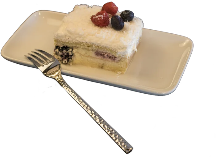 Slice of layered cake with fresh berries